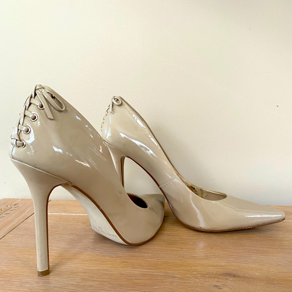 Nude color patent leather pumps with corset lace detail at back ankles